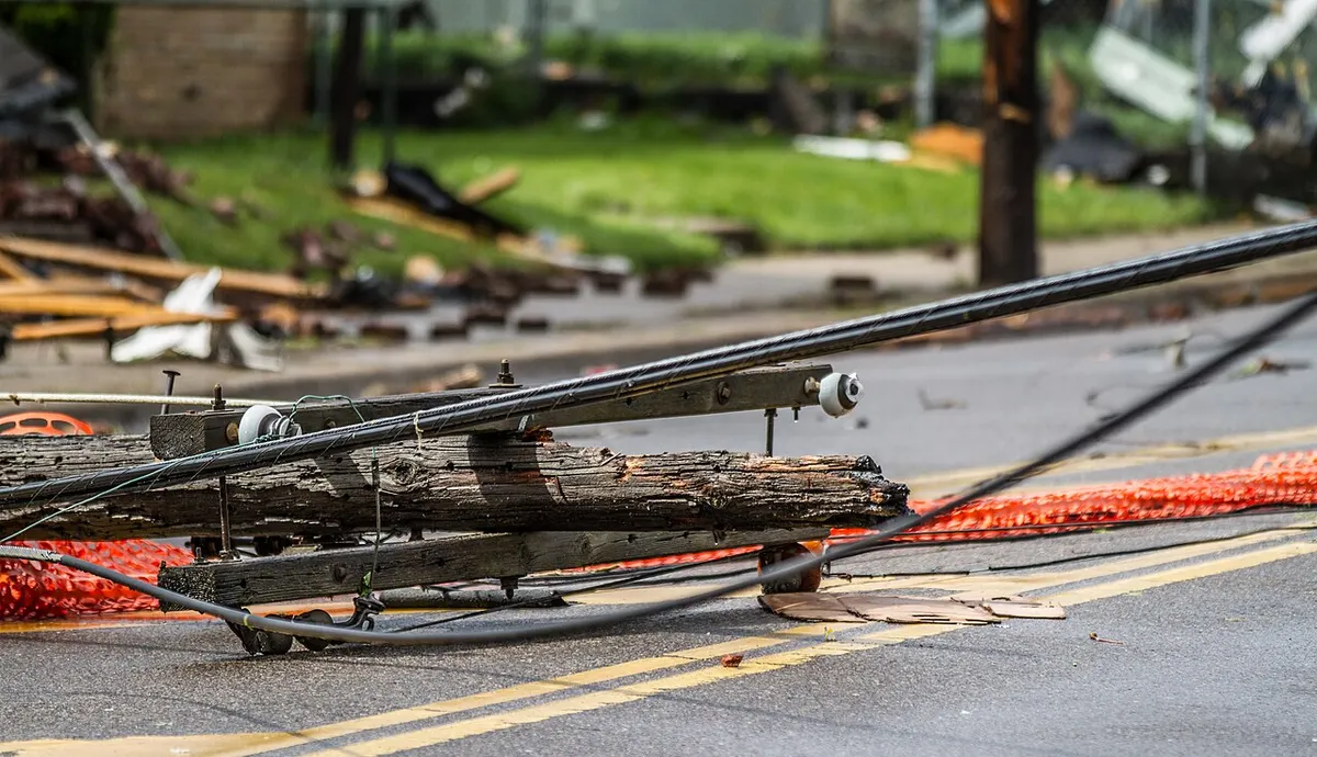 Downed power lines hanging over a street after a storm