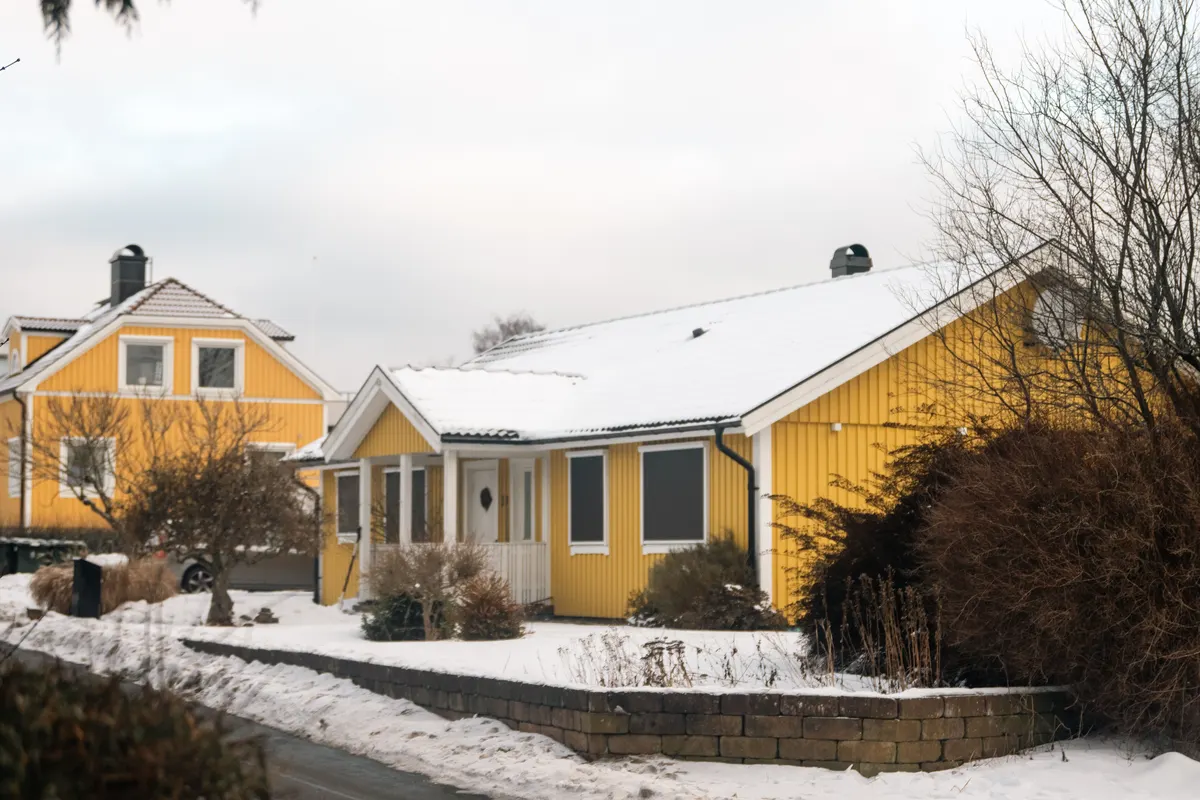 Snow covered house on a North Shore street during a winter power outage risk season